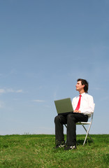 Man sitting outdoors using laptop