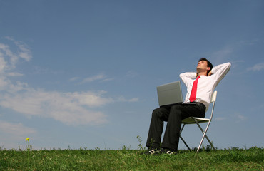 Man sitting outdoors using laptop