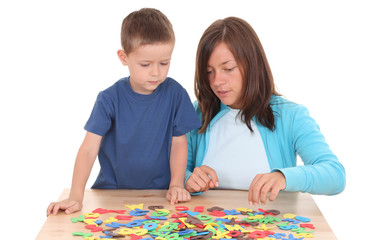 Fototapeta premium preschooler and mother playing with letters isolated on white