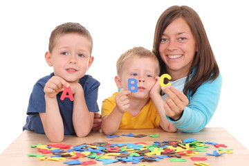 children and mother playing with letters isolated on white