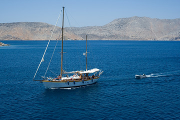 Fototapeta na wymiar Sailing ship and a small motor boat on the sea