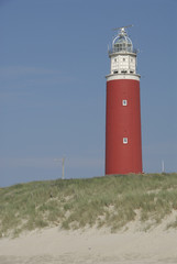 red lighthouse on the beach on texel (the netherlands)