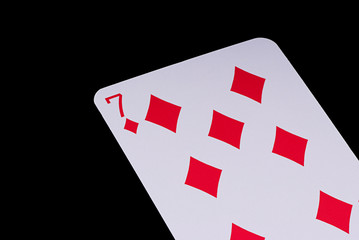 A poker card slanted view over black background