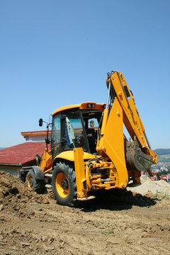 Excavator on a site in a new residential area
