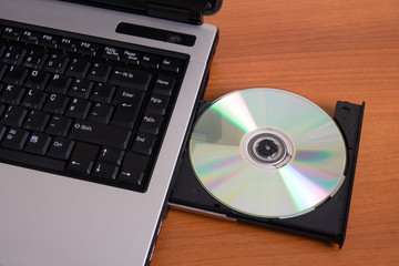 Partial top view of a laptop with the dvd recorder opened
