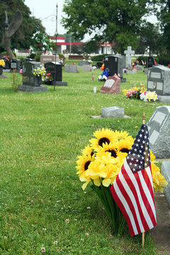 Flowers and flags decorate the lost loved ones