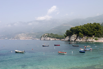 Boats In Montenegro Harbor With Blue Water