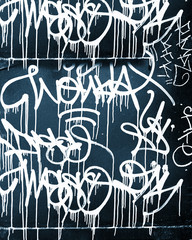 Dark blue background covered by layers of graffiti