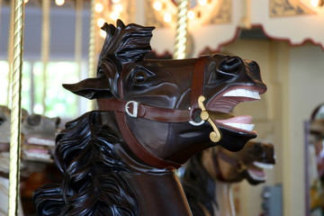 Fototapeta na wymiar A black horse on an merry-go-round