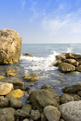Fototapeta na wymiar Sea coast with stones in the foreground