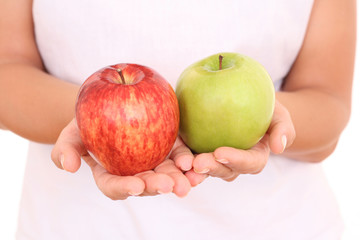 two apples red and green in hands on white