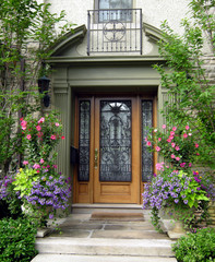 elegant house entrance with oak door and iron grille