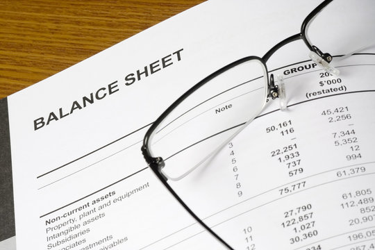 Balance sheet of a financial report with spectacles..