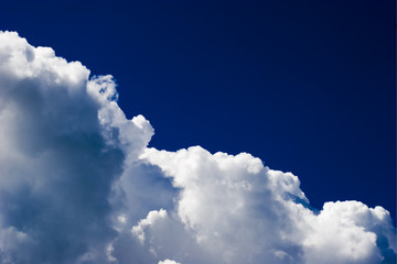 Majestic Cloudscape in vivid dark blue skyes background