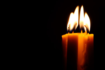 Four Candles isolated over dark background.
