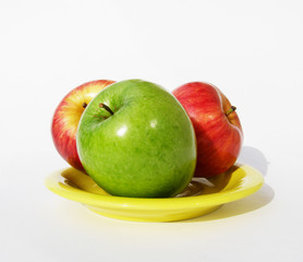 Three apples on a plate