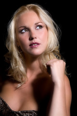 Beautiful blond woman on black background 