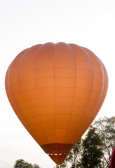 Fototapeta na wymiar A hot air balloon beginning to lift