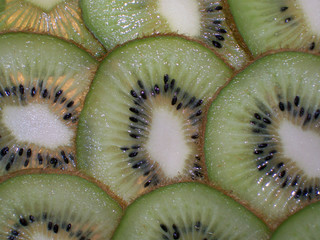 an image of overlapping sliced kiwi fruit