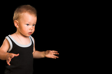 Young going child isolated on the black background