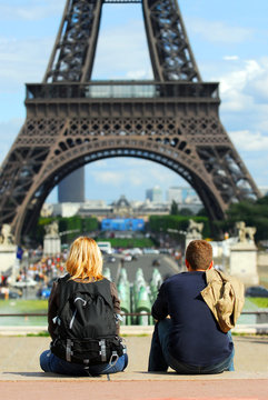 Young tourists enjoying the view of Eiffel tower in Paris.