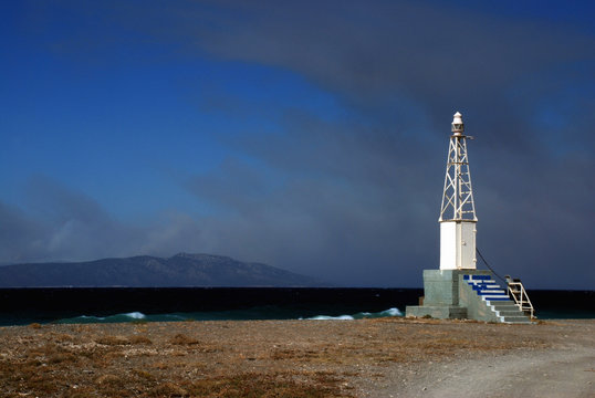 Small lighthouse in Greece and a dramatic sky
