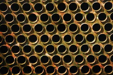 Old corroded perforated metalic surface.