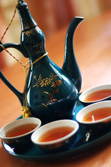 Elegant china set with freshly made tea.