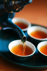 Pouring fresh tea to elegant china teacups.  - 3845381