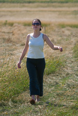 happy girl on field walking