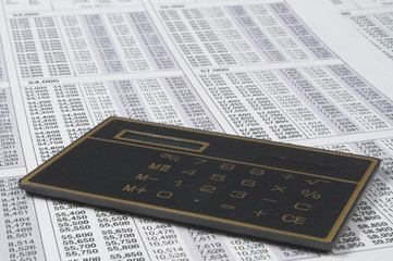 A calculator on top of tax forms.