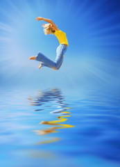 Beautiful woman jumping over the water