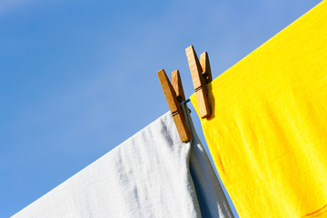 Linen and two clothes-pegs against the blue sky