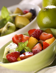 mixed fresh fruit in green bowl close up