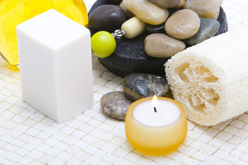 Spa items, rocks, candle and loofah