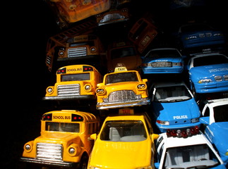 Pile of Toy Cars: Yellow Taxis, School Buses and Police Cars