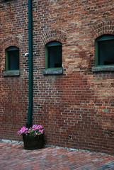 Fototapeta na wymiar Rustic bricks wall and a flower basket