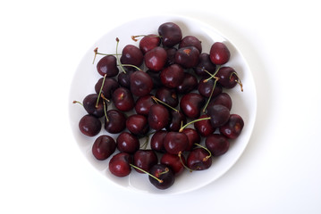 black cherries on a white plate