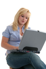 Naklejka premium A pretty young woman working on a laptop computer