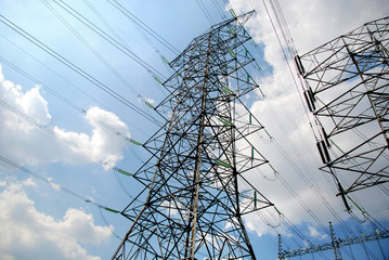 a group of high voltage tower in the blue sky