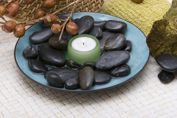 Fototapeta na wymiar Spa stones and candle in a bowl