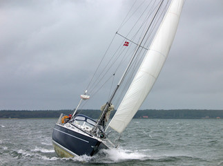 Sailboat racing in the winter in strong winds and rough sea