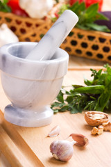 Cooking with herbs, vegetables marble mortar and pestle.