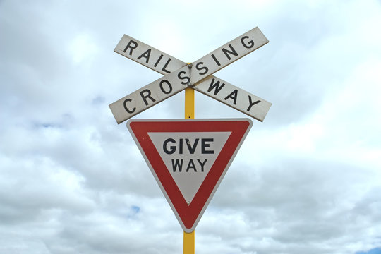 give way railway crossing sign