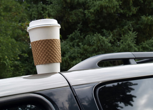 Disposable Coffee Cup Left On Top Of A Vehicle