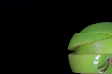 A sliced green apple in a stack.