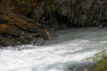 Naklejka na ściany i meble Flowing stream and rocks