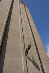 A person abseiling down a tall building