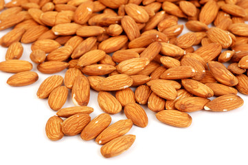 A group of shelled almond nuts on a white background.