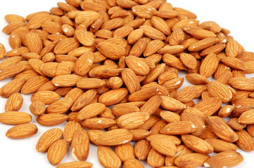 A group of shelled almond nuts on a white background.